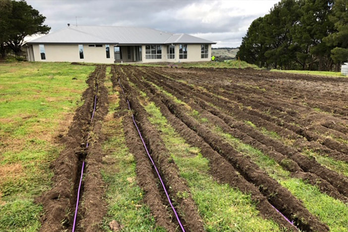 Irrigation channels running toward a house